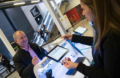 An attendee receiving their digital badge from onsite staff at an event